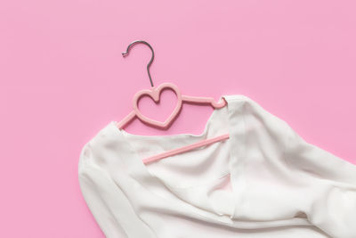 Close-up of heart shape against pink background