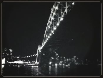 Illuminated bridge at night