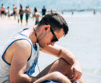 Young man looking at sea shore