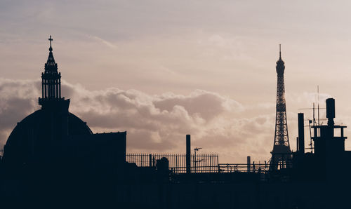 Silhouette of paris building against sky during sunset