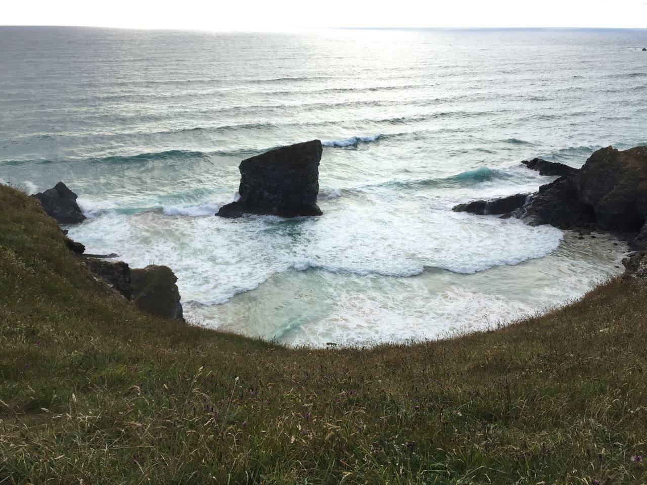 ROCKS IN SEA AGAINST SKY