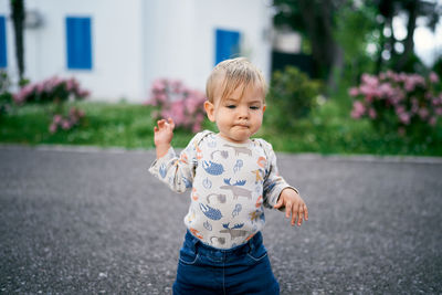 Cute boy standing on road