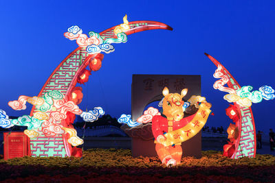 Low angle view of illuminated lantern against sky at night