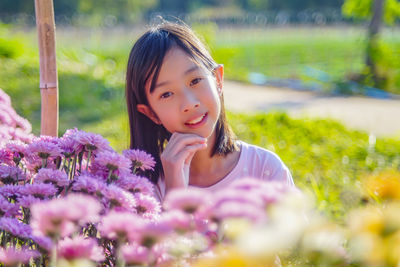 Portrait of beautiful woman with red flower