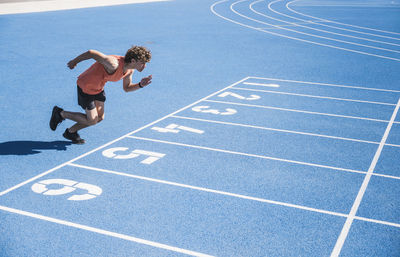 Young athlete running on track