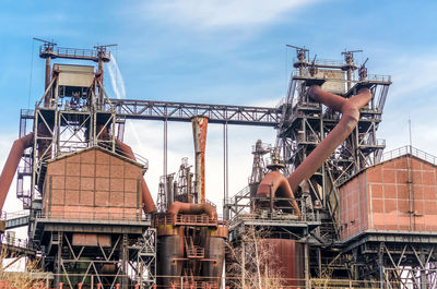 Low angle view of factory against sky