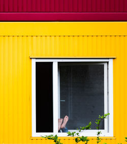 Close-up of window on yellow wall