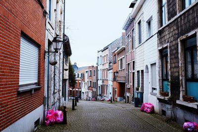 Street amidst buildings against sky