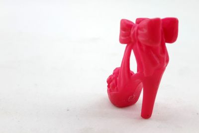 Close-up of red toy tied on table
