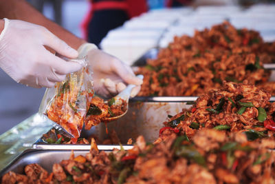 Close-up of hand holding meat at market