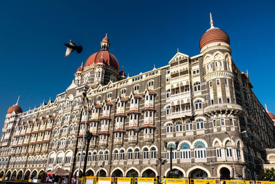 Low angle view of building against clear blue sky
