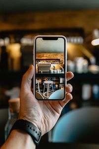 Midsection of man using mobile phone