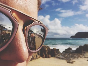 Reflection of beach on sunglasses