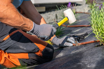Low section of man working at workshop