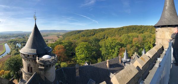 Panoramic view of trees and buildings against sky