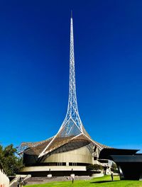 Low angle view of tower against blue sky