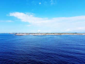 Scenic view of sea against blue sky