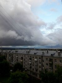 View of cityscape against cloudy sky