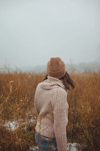 Young female in a foggy late autumn forest