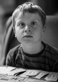 Portrait of boy with book on table