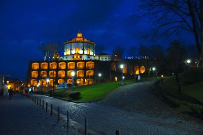 Illuminated buildings against sky at night