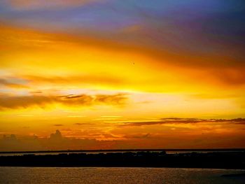 Scenic view of dramatic sky over sea during sunset