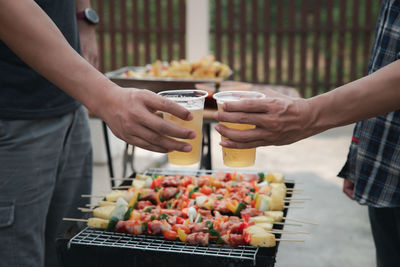 Midsection of people holding food