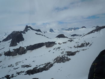 Scenic view of snow covered mountains against sky