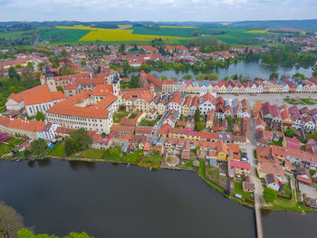 High angle view of townscape by river in city