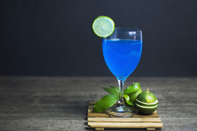 Close-up of drink on table against black background