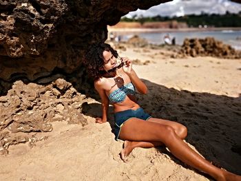 Full length of young woman at beach