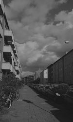 Buildings in city against cloudy sky