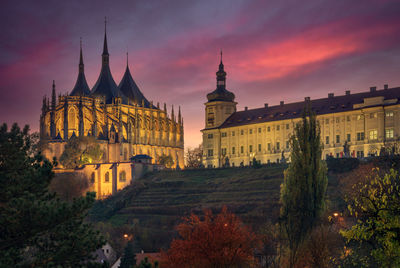 Cathedral of buildings against sky during sunset