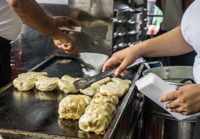 Midsection of man preparing food in kitchen