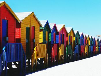 Colorful umbrellas on beach against clear blue sky