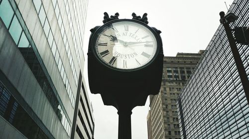 Low angle view of clock tower against sky