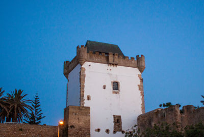 Low angle view of built structure against clear blue sky