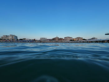 Scenic view of sea against clear blue sky