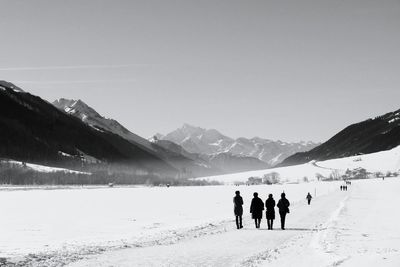 Tourists on snow covered landscape