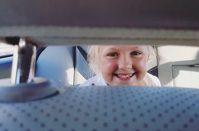 Portrait of a smiling young woman in car