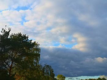 Low angle view of rainbow against cloudy sky