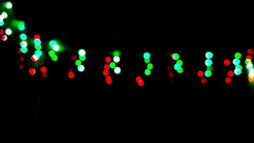 Close-up of illuminated lights against black background