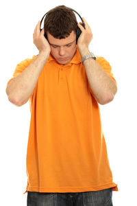 Low section of boy standing against white background