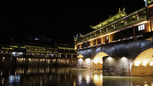 Illuminated buildings with waterfront at night