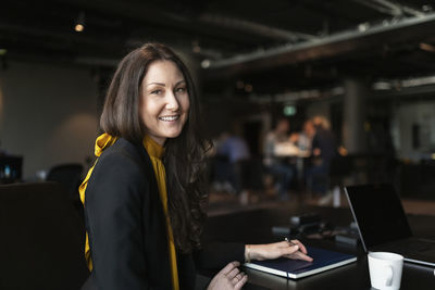 Smiling businesswoman looking at camera