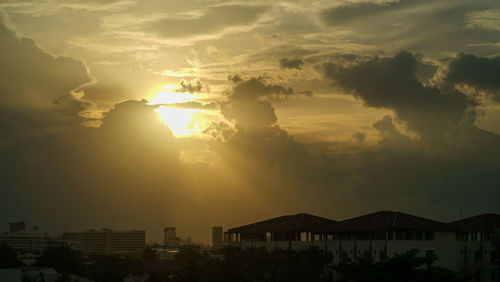 Silhouette buildings against sky during sunset