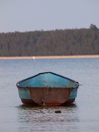 Close-up of boat in water against sky