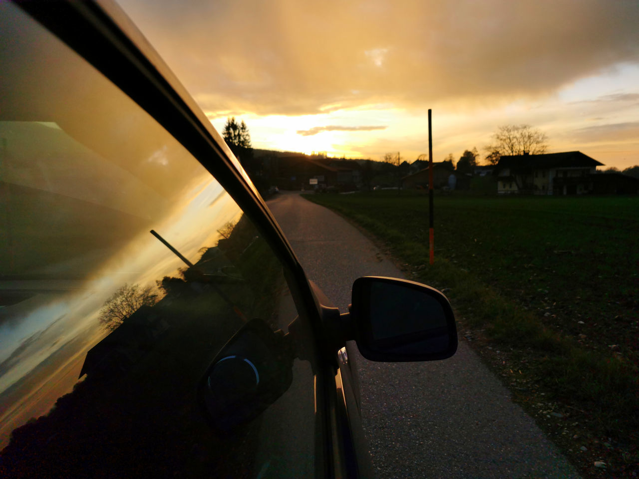 CAR ON ROAD AGAINST SKY