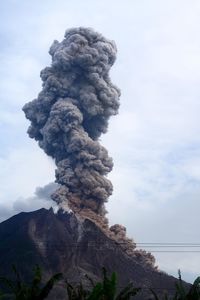 Low angle view of mountain against cloudy sky