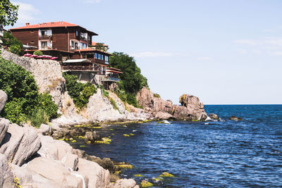 Scenic view of sea and buildings against sky